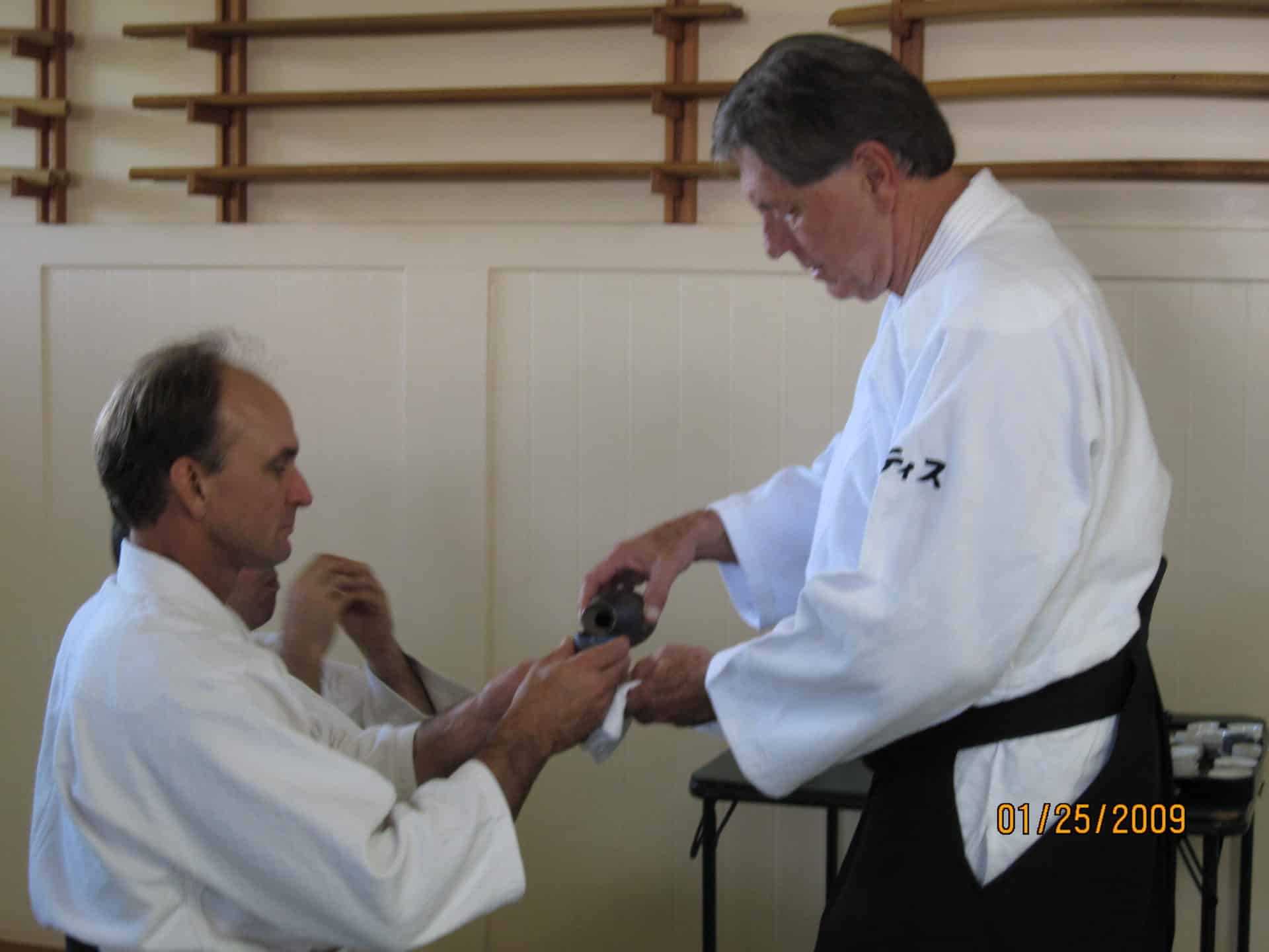 Curtis Sensei pouring Omiki for Senior Instructor Jeff Baldwin